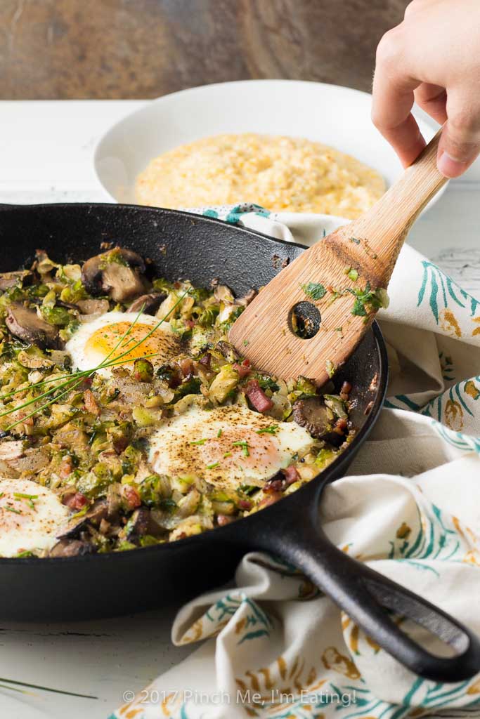 Brussels sprout hash with pancetta, mushrooms, and an egg on top is perfect for breakfast OR dinner, served with cheesy grits!