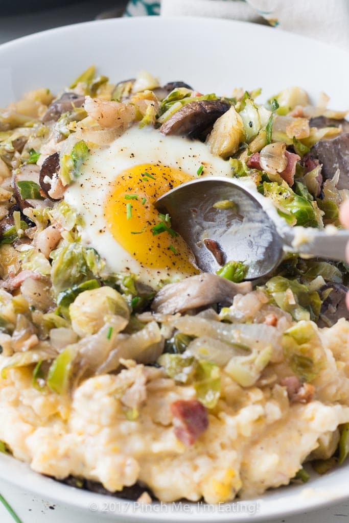 Brussels sprout hash with pancetta, mushrooms, and an egg on top is perfect for breakfast OR dinner, served with cheesy grits!