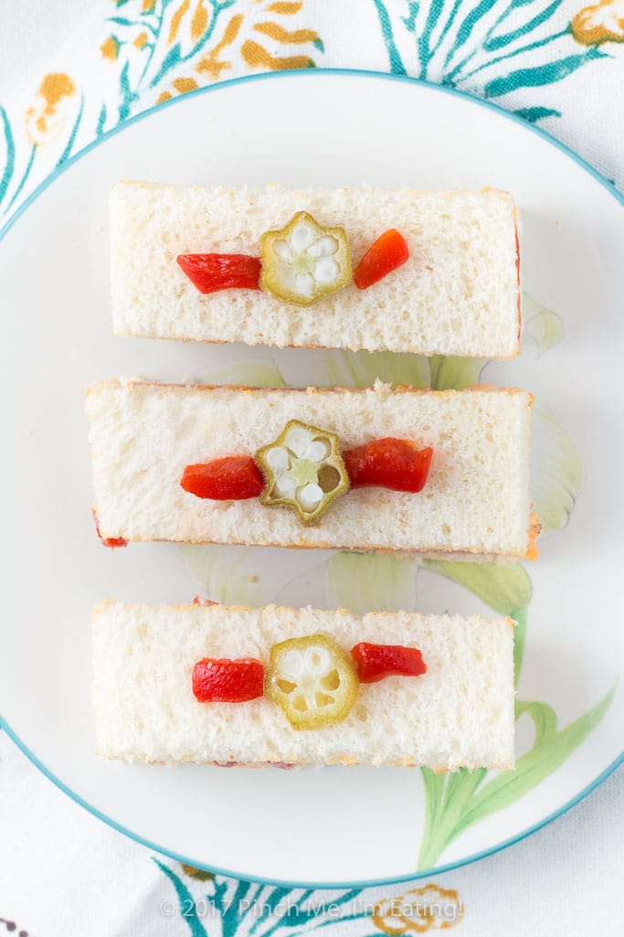 These adorable ham and pimento cheese tea sandwiches would be perfect for a Southern tea party or afternoon tea! And they're topped with the cutest pickled okra garnishes!
