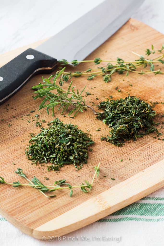 Rosemary thyme no-knead Dutch oven bread is airy and soft on the inside with a glossy crust that shatters when you cut into it - the perfect crusty bread for stew or just dipping into olive oil! Best of all, you hardly have to do anything to make it!