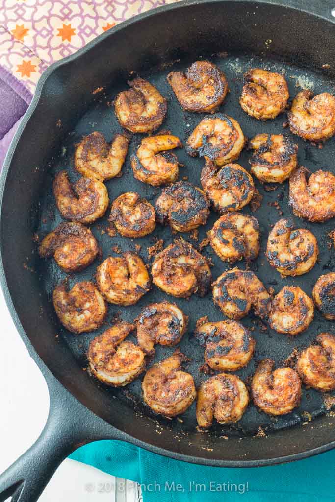 Overhead shot of blackened shrimp in cast iron skillet