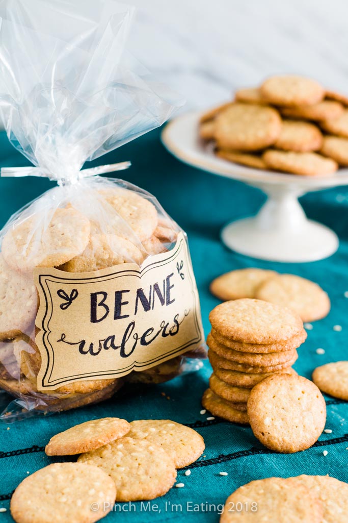 Benne wafers stacked surrounding cellophane bag of benne wafers