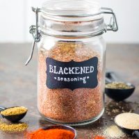 Blackened seasoning in glass spice jar surrounded by spices