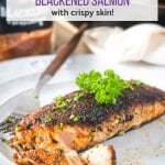 Flaky blackened salmon on a white plate