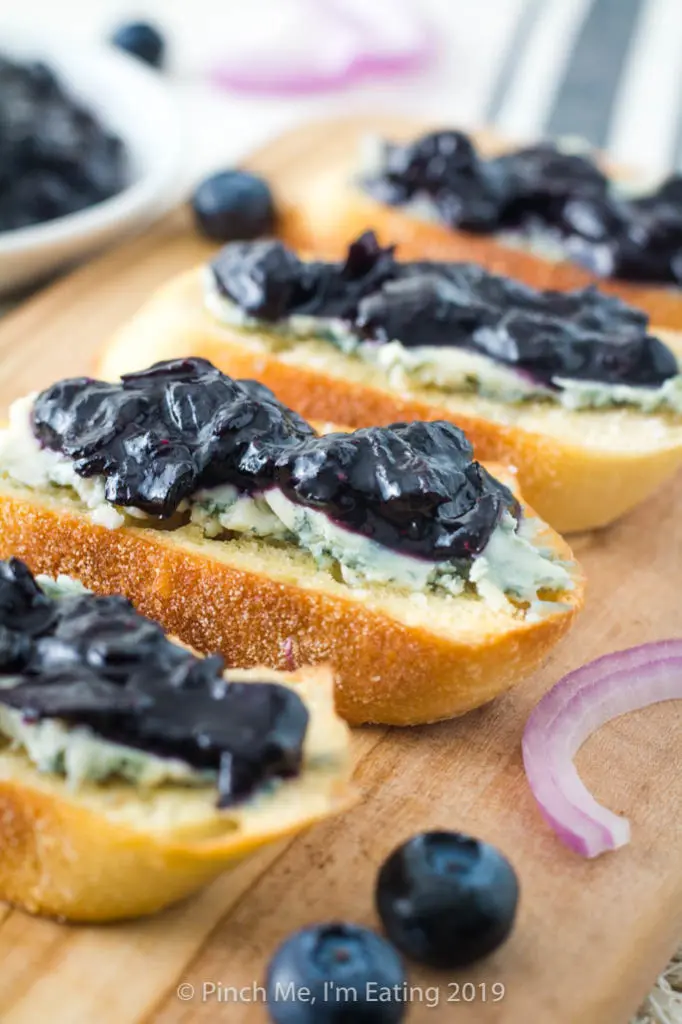 Sweet and savory blueberry and caramelized red onion jam on crostini with blue cheese