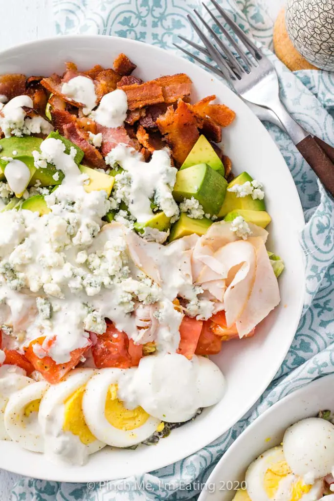 Overhead shot of turkey Cobb salad in a white dish