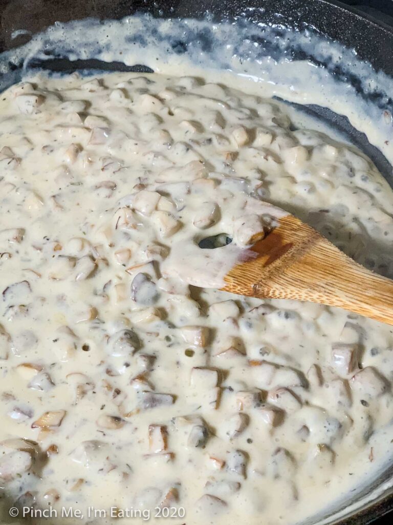 Homemade cream of mushroom soup with a wooden spoon