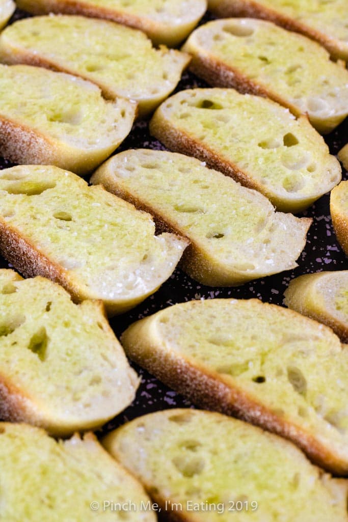 Crostini arranged on a baking sheet.