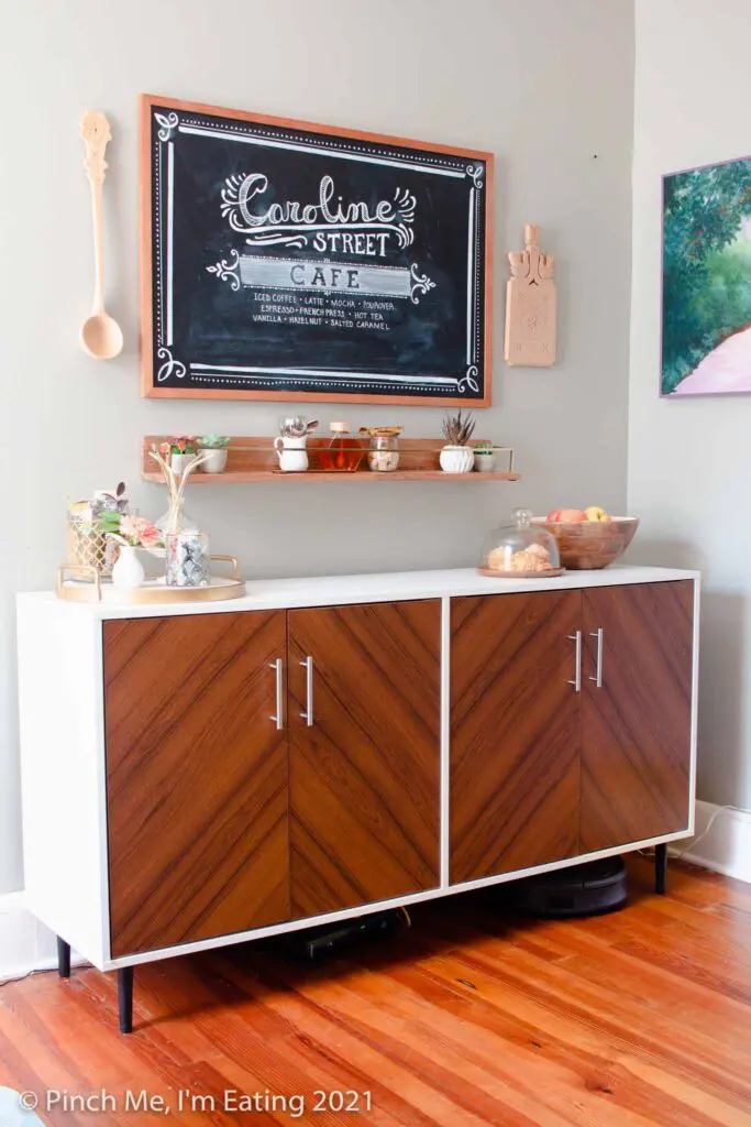 DIY at-home coffee station ideas - coffee bar on dining room buffet with fruit and pastry display, floating shelf, and menu chalkboard