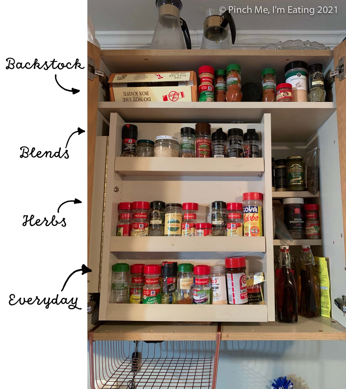 Cabinet with swinging spice shelf insert - labeled with organization