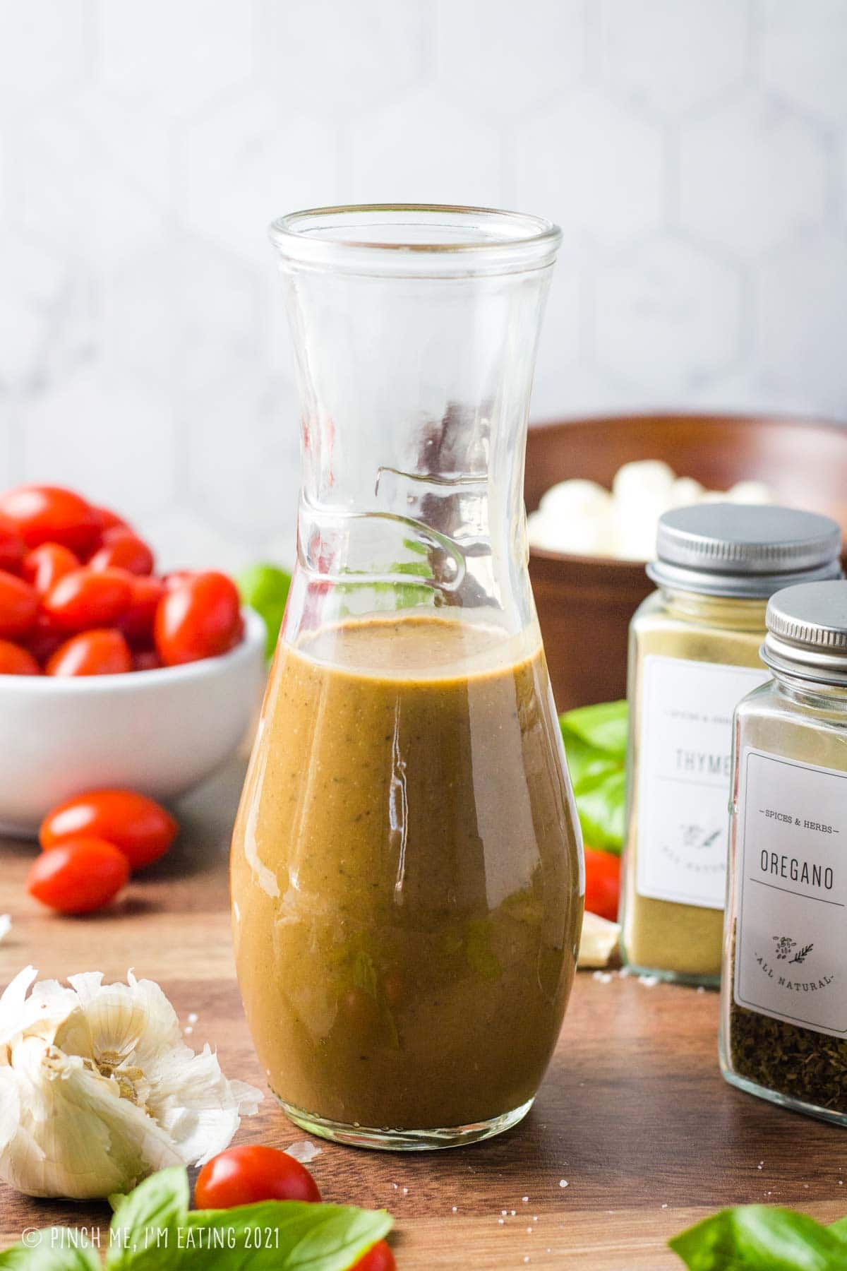 Creamy balsamic dressing in a glass bottle.