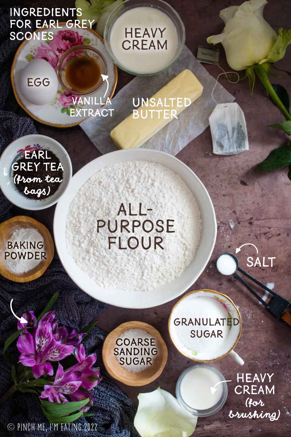 Ingredients for making Earl Grey scones with butter, cream, and tea leaves.