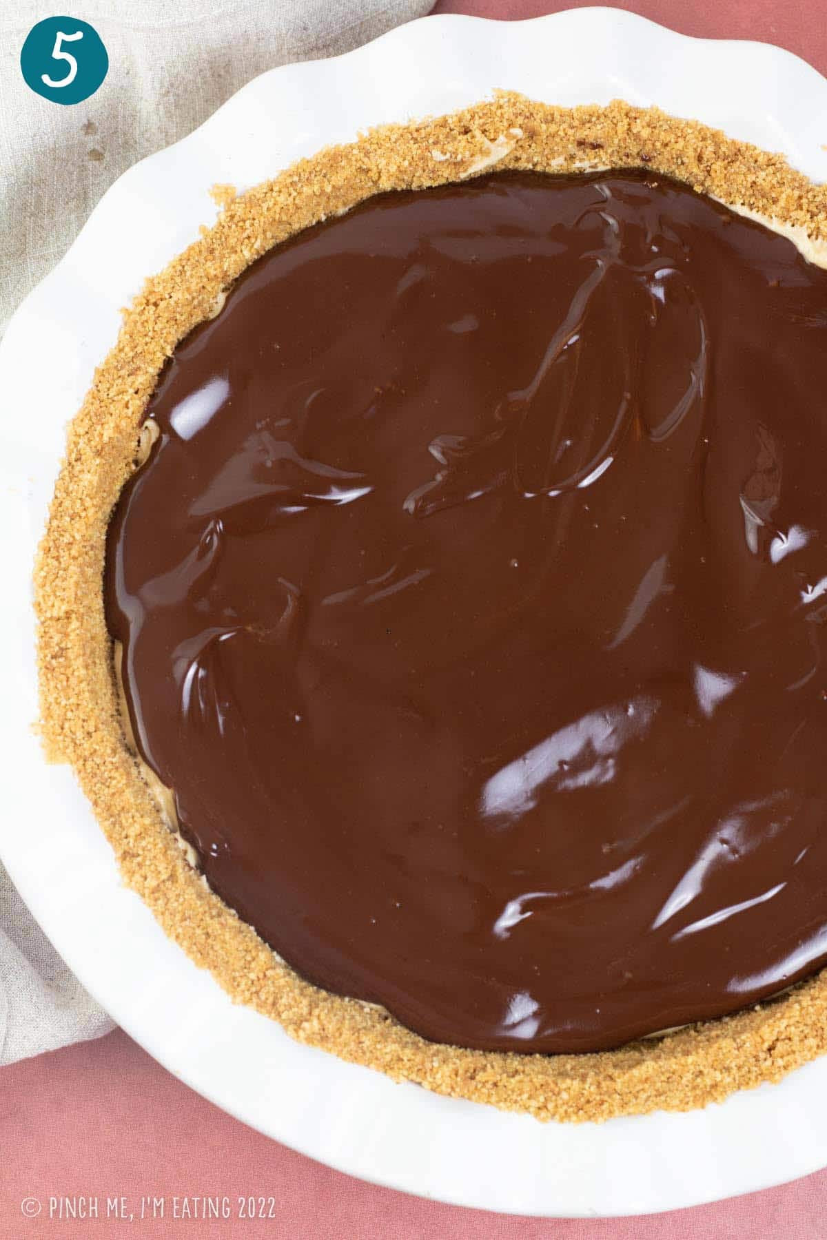 Chocolate ganache spread on top of pie.