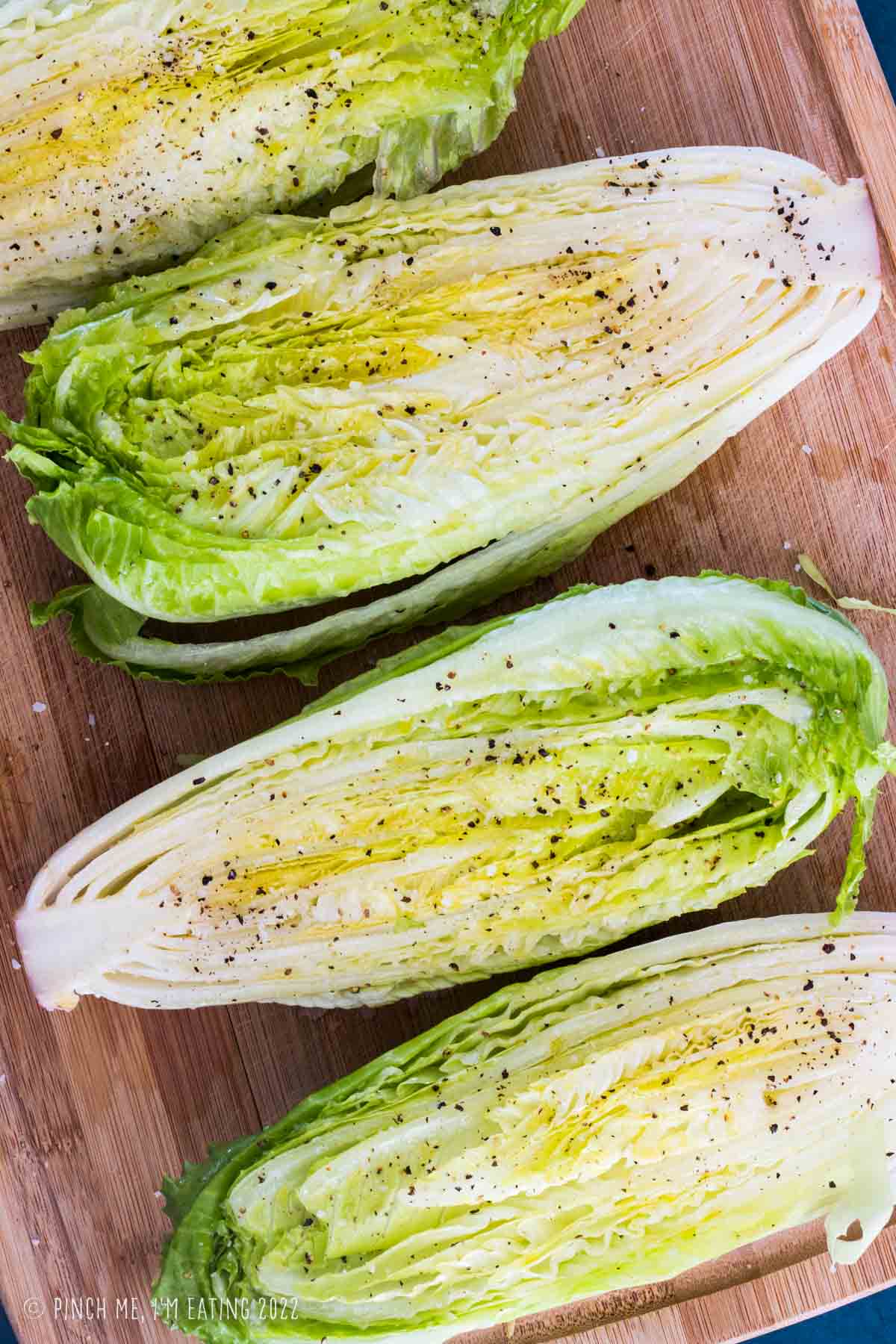 Romaine halves sprinkled with salt and pepper.