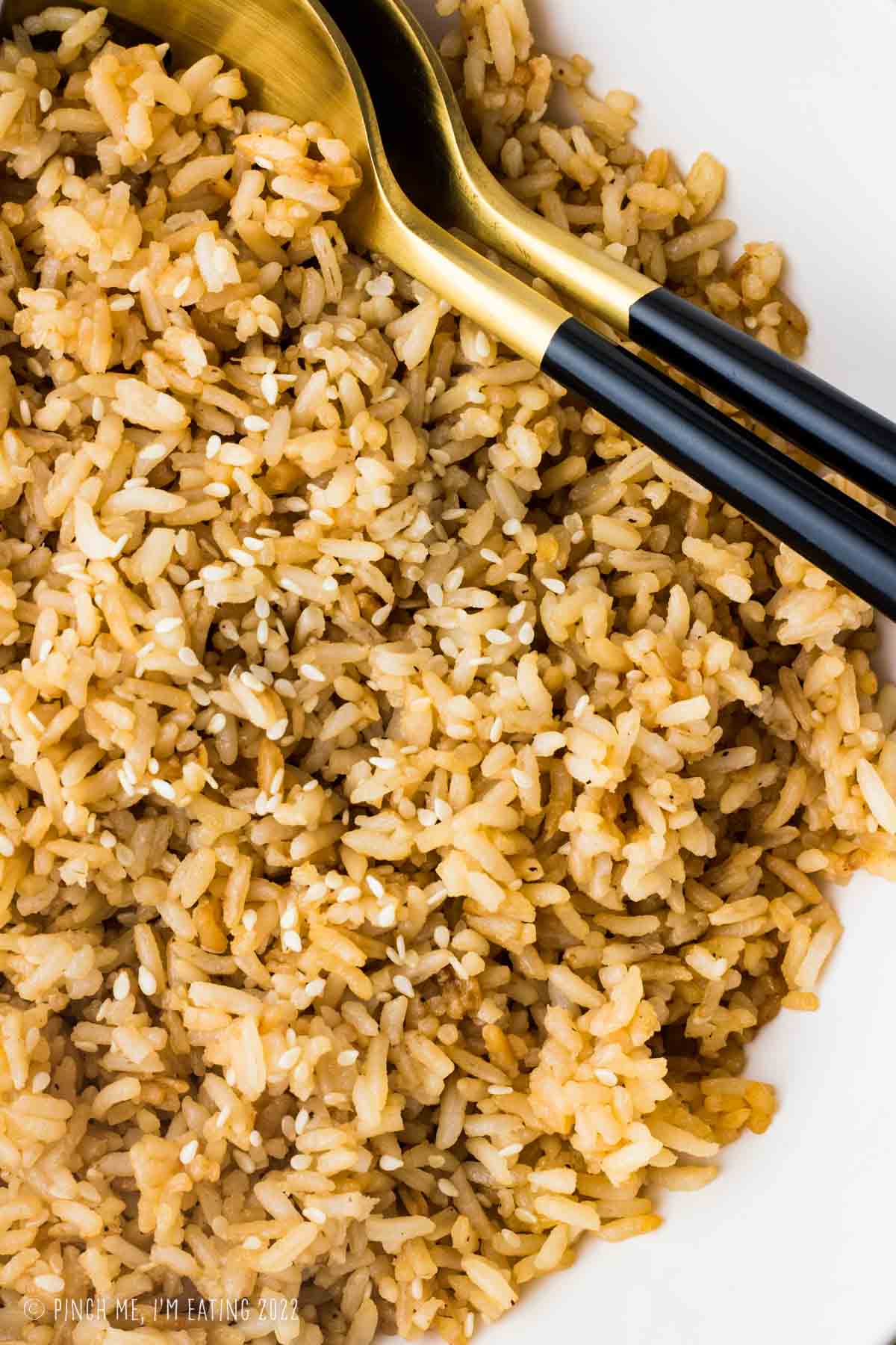 Close-up of hibachi fried rice in a white bowl.