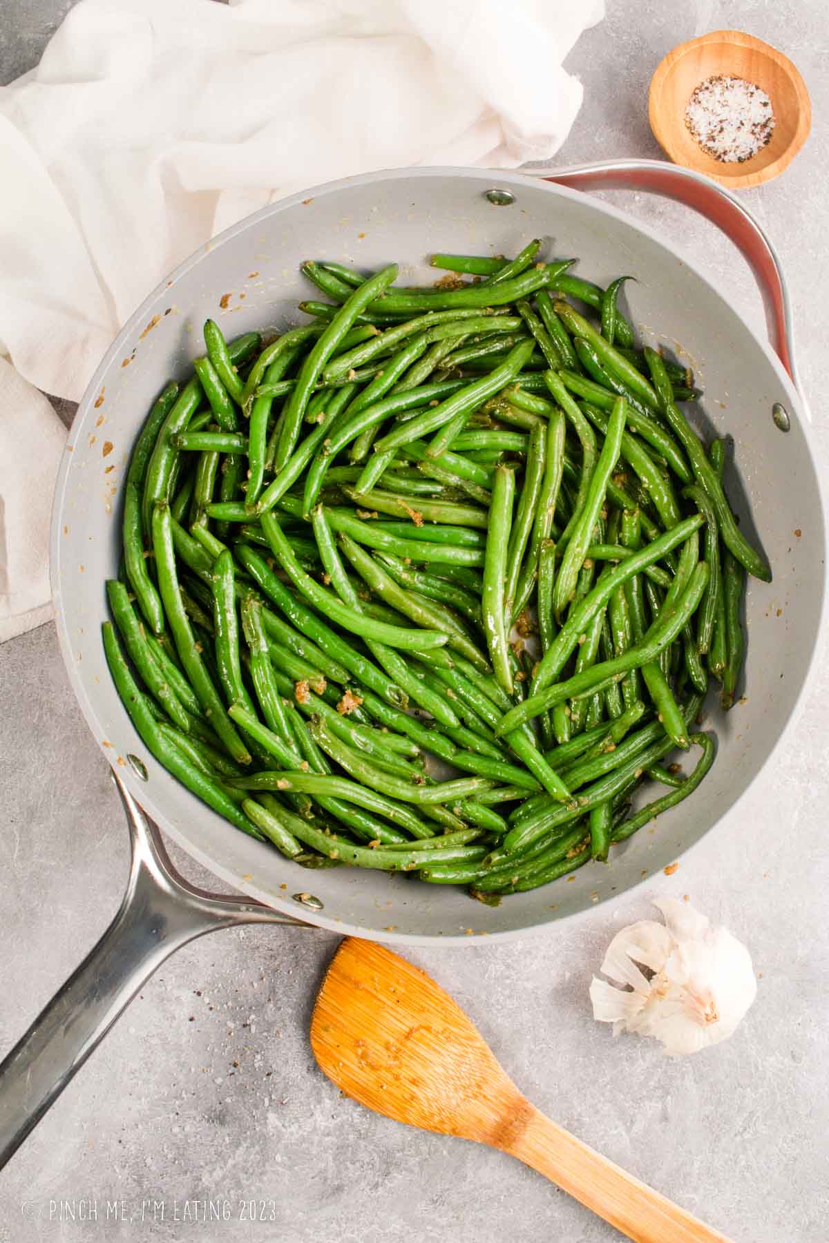 Steakhouse style sautéed garlic butter green beans in a sauté pan.