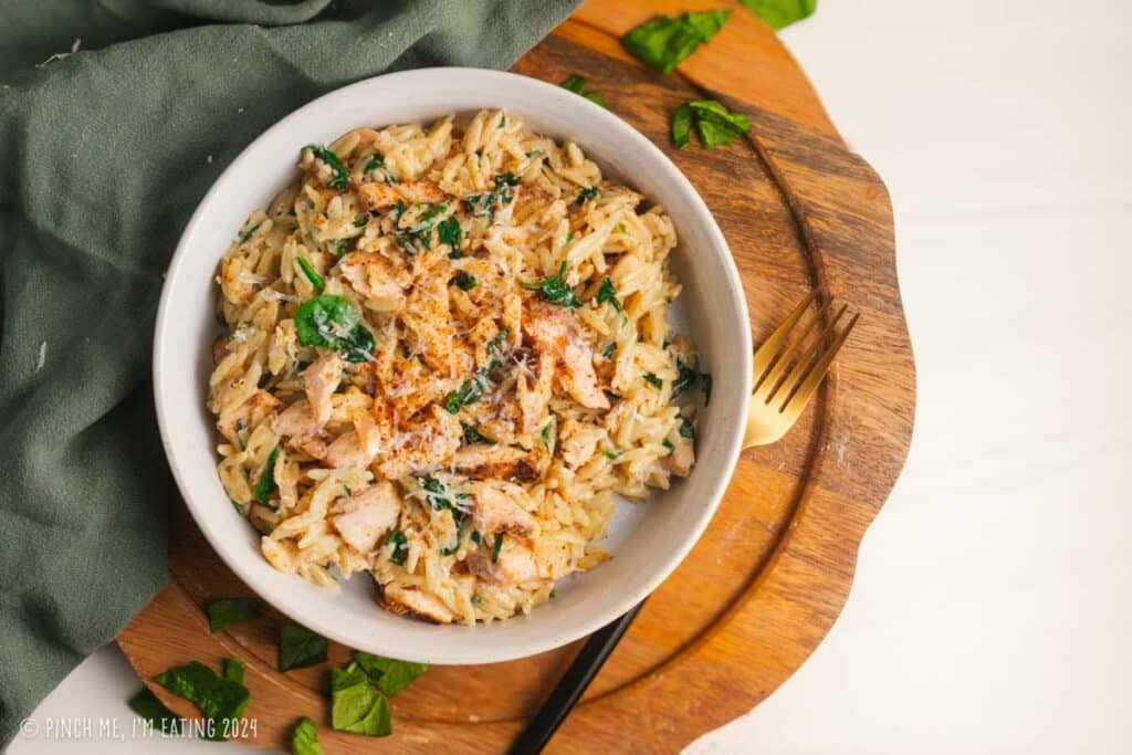 Creamy parmesan spinach orzo with flaky leftover blackened salmon.