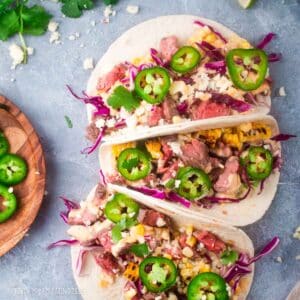 Flank steak tacos with corn and chipotle aioli.