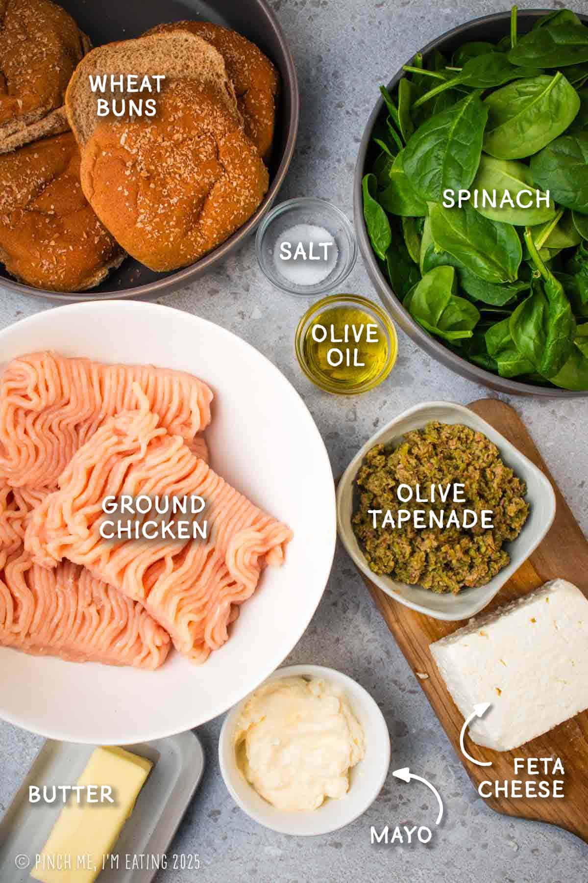 Labeled ingredients for chicken burgers, including ground chicken, spinach, wheat buns, olive tapenade, and feta cheese.