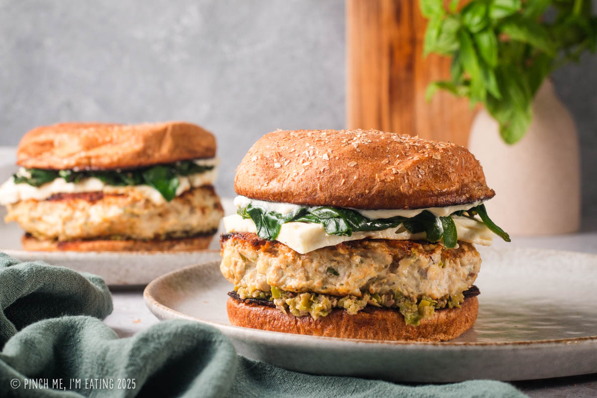 Chicken feta burgers with spinach on a wheat bun.
