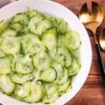 Cucumber salad in a white bowl.