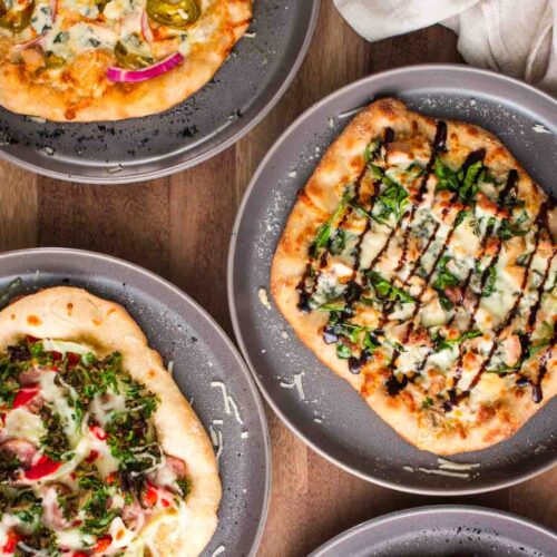 Multiple personal sized pizzas for a build your own pizza party.