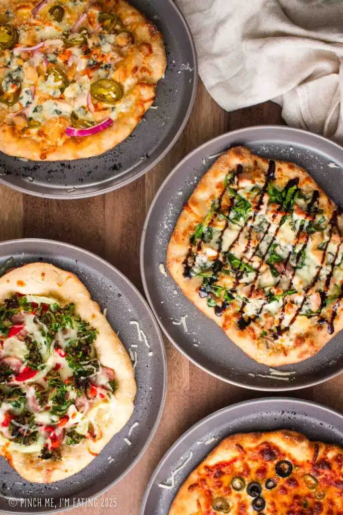 Multiple personal sized pizzas for a build your own pizza party.