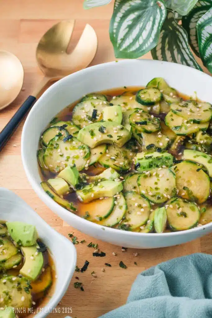 Asian cucumber and avocado salad in a white bowl.