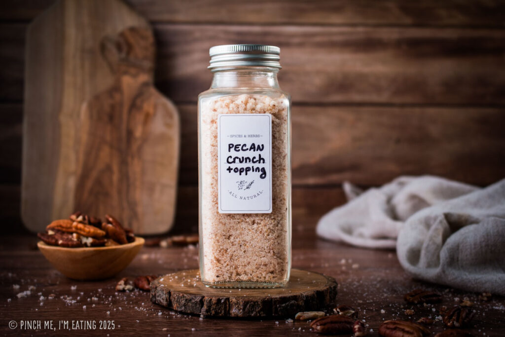Pecan crunch topping in a glass jar.