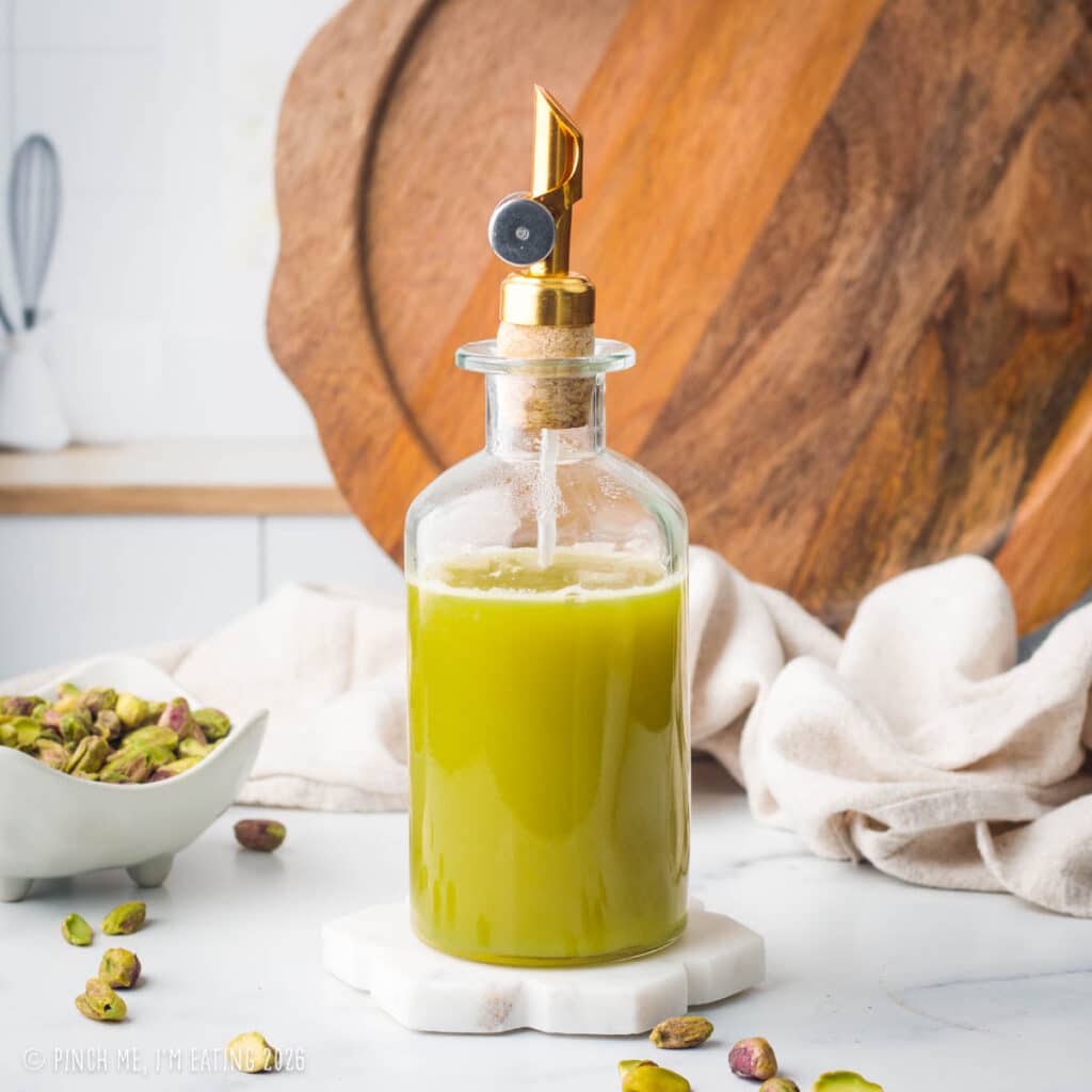 Green coffee syrup in a glass bottle.