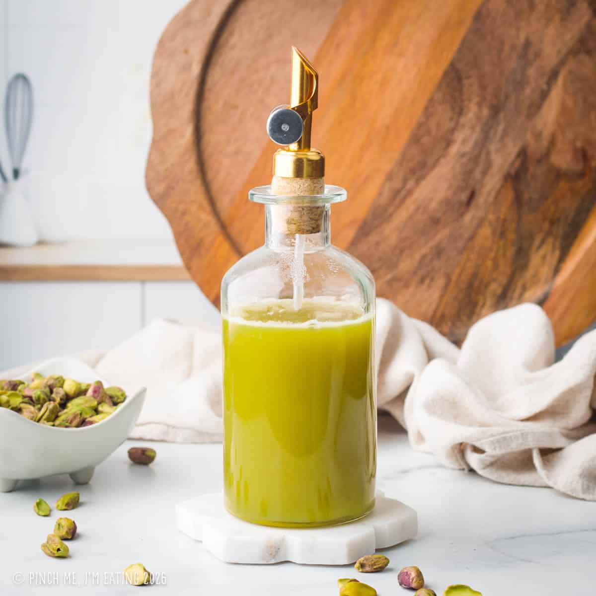 Green coffee syrup in a glass bottle.